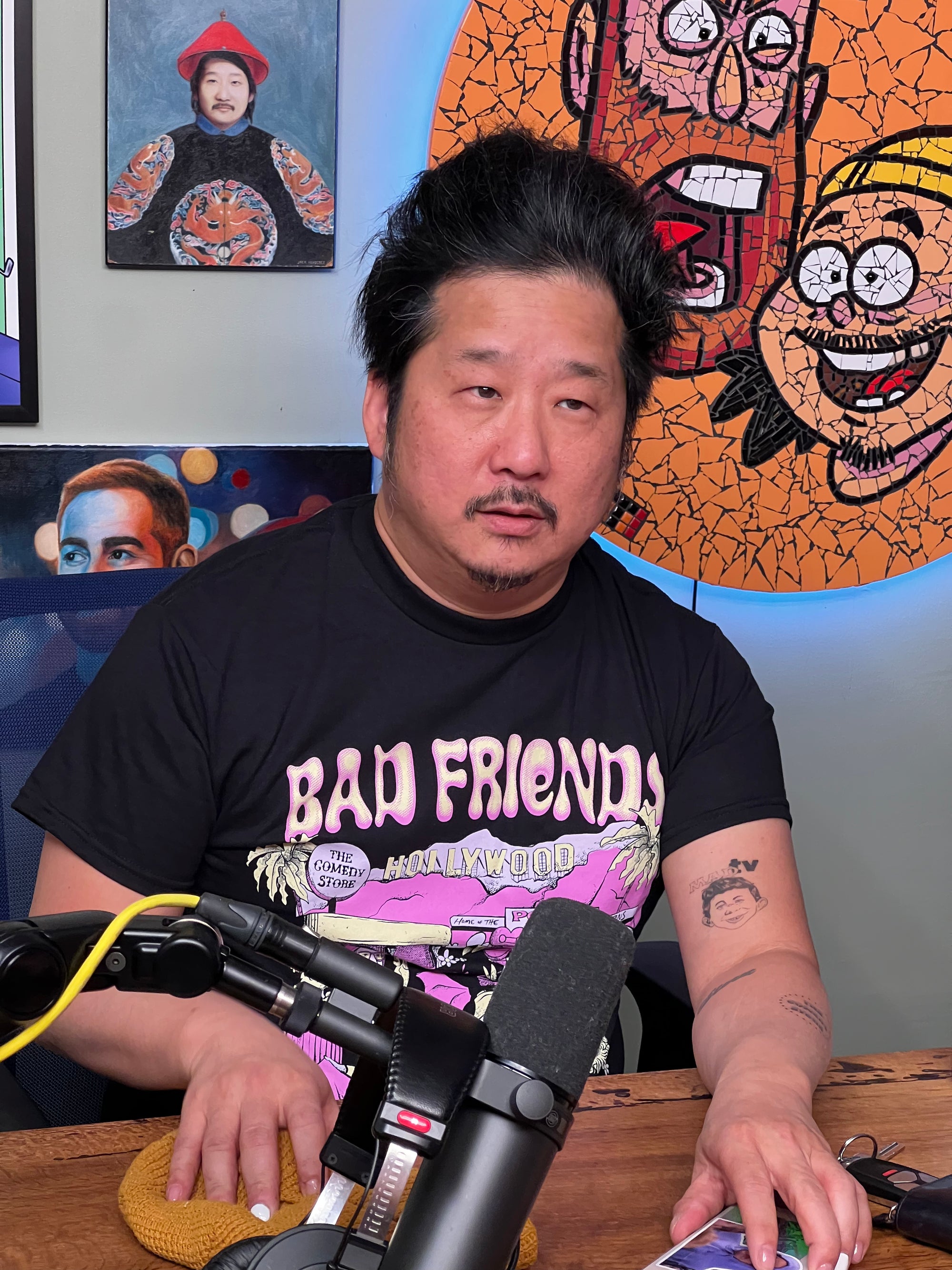 Bobby in his black bad friends world t-shirt at his podcast chair